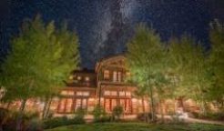 Wide image of The Ranch at Rock Creek at night under a starry sky.